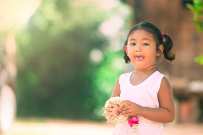 Portrait of cute girl standing outdoors