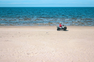 Man riding motorcycle on beach