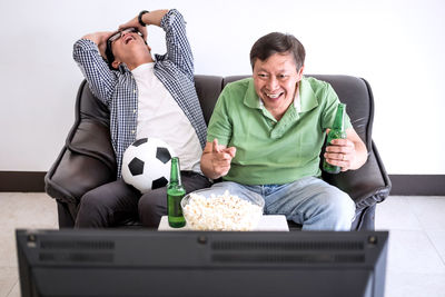 Friends watching soccer on tv