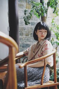 Portrait of a smiling woman sitting outdoors