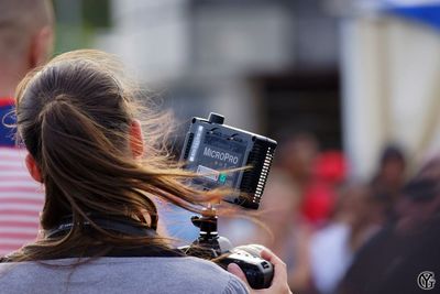 Young woman photographing through smart phone in park