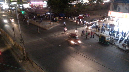 Crowd on road in city at night