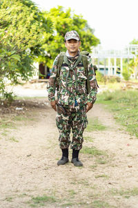 Portrait of smiling boy standing against plants