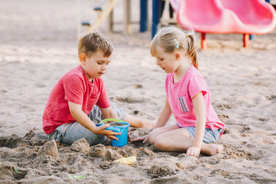 Children playing with toys on sand at beach