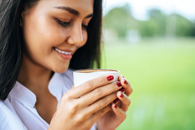 Close-up of a young woman drinking coffee