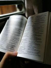 Close-up of hand holding book