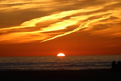 Scenic view of sea against romantic sky at sunset