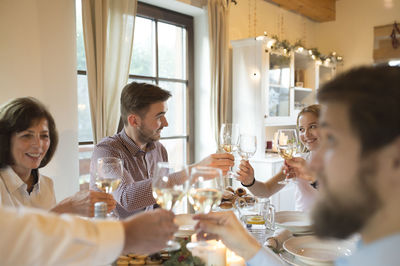 Family clinking glasses at christmas dinner