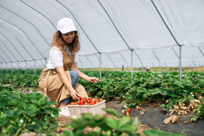 Woman standing in greenhouse