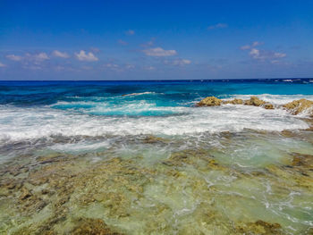 Scenic view of sea against blue sky