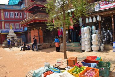 People at market stall building