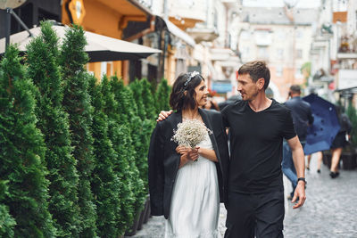 Side view of couple holding hands