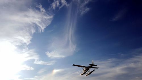 Low angle view of airplane flying in sky