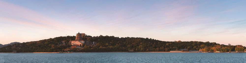 View of building by sea against sky