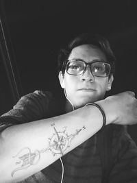 Portrait of man wearing eyeglasses at home