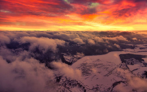 Scenic view of snow covered landscape against dramatic sky