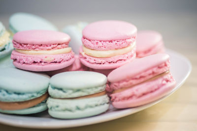 Close-up of pink and blue macaroons on table