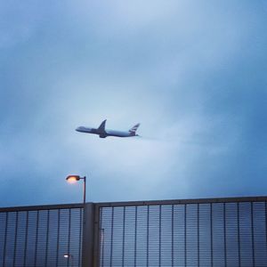 Low angle view of airplane flying in sky