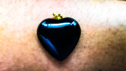 Close-up of heart shaped ring on wall