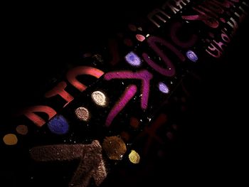 High angle view of illuminated lighting equipment against black background