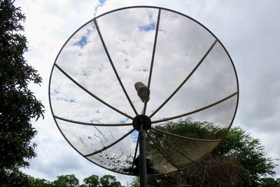 Low angle view of communications tower against sky