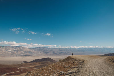 Scenic view of landscape against blue sky