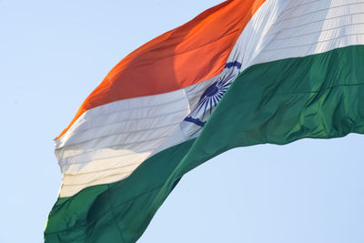 India flag flying high at connaught place with pride in blue sky, india flag fluttering, indian flag