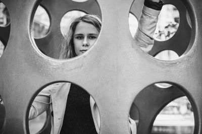 Portrait of young woman in play equipment at playground