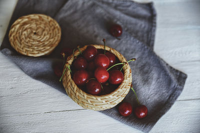 High angle view of strawberries in basket on table