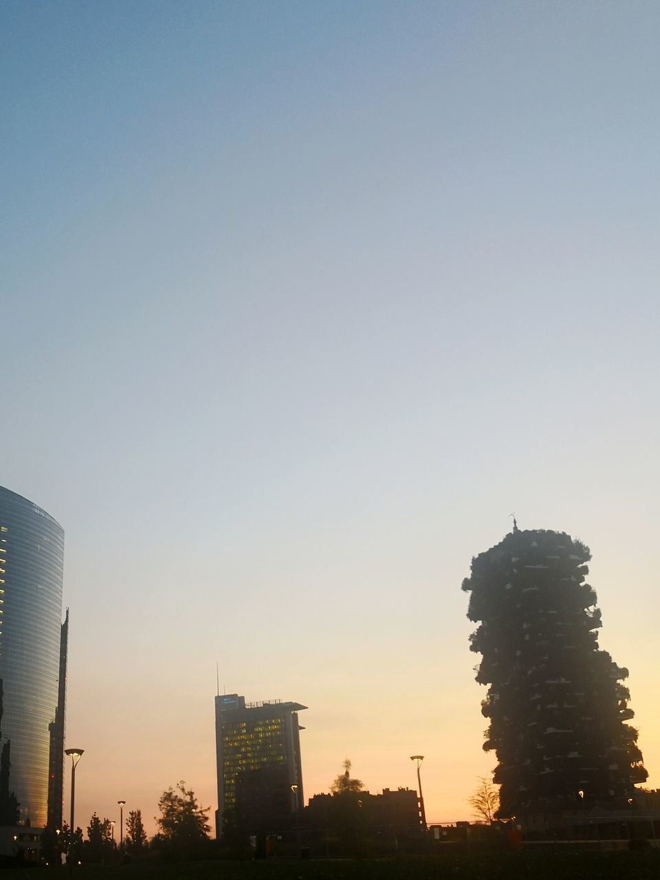 MODERN BUILDINGS IN CITY AGAINST CLEAR SKY