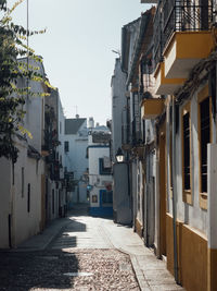 Narrow street amidst buildings against sky