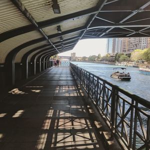 Bridge over river amidst buildings in city