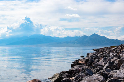 Scenic view of lake and mountains against sky