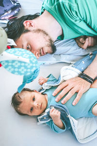 High angle view of father playing with daughter