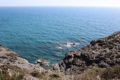 High angle view of rocks on sea against sky