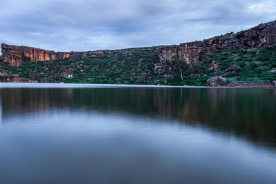 Lake pristine with mountain background and bright sky long exposure