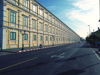 Road by building against sky