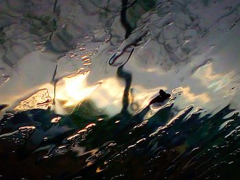 Low angle view of reflection in sea against sky