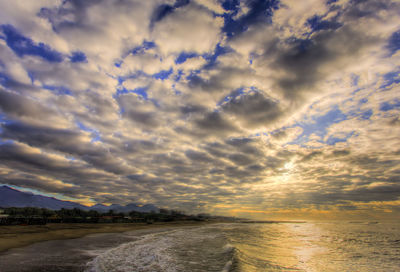 Scenic view of beach against sky during sunset