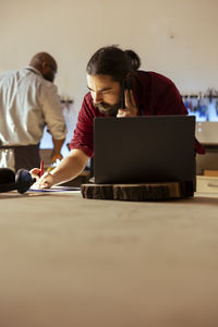 Young woman using laptop at office