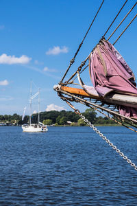 Sailboat sailing on sea against sky