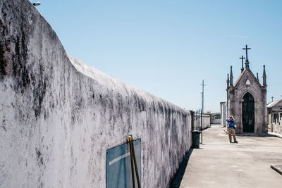 Woman standing against wall