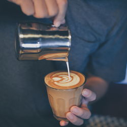 Midsection of man preparing coffee