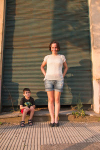 Mother and son posing together in the street