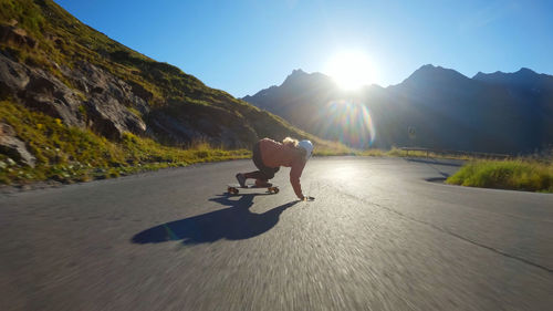 Rear view of people walking on road