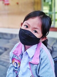Portrait of young woman standing outdoors