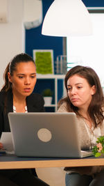 Young woman using laptop at office