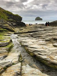 Scenic view of beach against cloudy sky