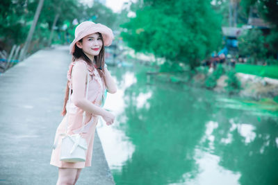 Portrait of young woman standing in water