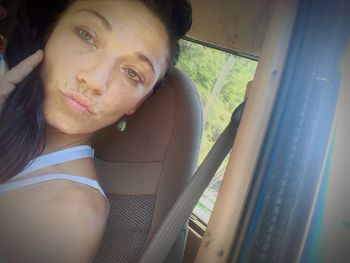 Portrait of smiling young woman in car